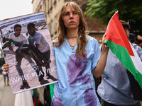 A woman attends solidarity with Palestine demonstration at Kazimierz, the Jewish historic district in Krakow, Poland on June 30, 2024.  A pr...