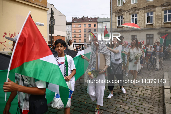 People attend solidarity with Palestine demonstration marching in Kazimierz, the Jewish historic district in Krakow, Poland on June 30, 2024...