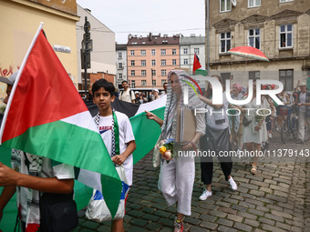 People attend solidarity with Palestine demonstration marching in Kazimierz, the Jewish historic district in Krakow, Poland on June 30, 2024...