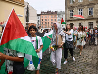 People attend solidarity with Palestine demonstration marching in Kazimierz, the Jewish historic district in Krakow, Poland on June 30, 2024...