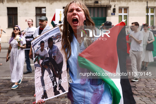 A woman attends solidarity with Palestine demonstration at Kazimierz, the Jewish historic district in Krakow, Poland on June 30, 2024.  A pr...