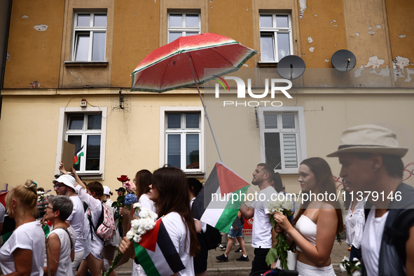 People attend solidarity with Palestine demonstration marching in Kazimierz, the Jewish historic district in Krakow, Poland on June 30, 2024...