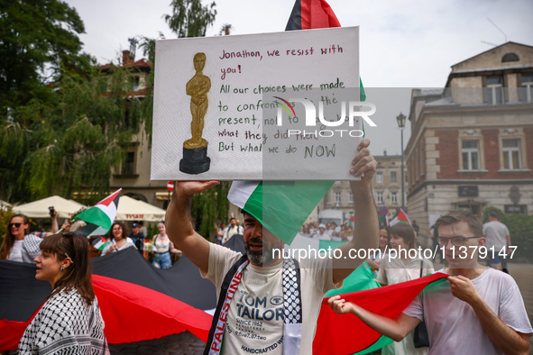 People attend solidarity with Palestine demonstration marching in Kazimierz, the Jewish historic district in Krakow, Poland on June 30, 2024...