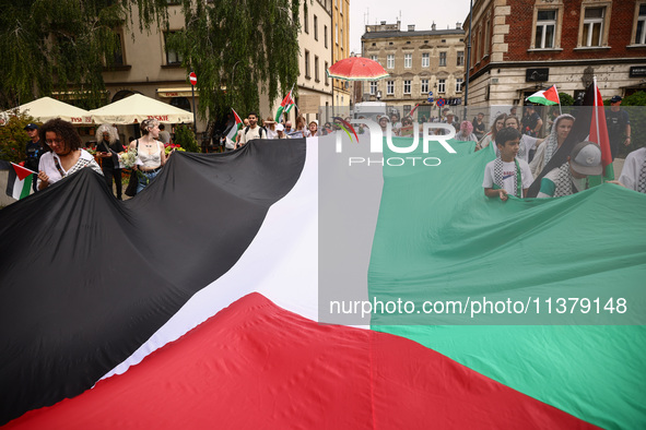 People attend solidarity with Palestine demonstration marching in Kazimierz, the Jewish historic district in Krakow, Poland on June 30, 2024...