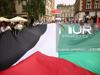 People attend solidarity with Palestine demonstration marching in Kazimierz, the Jewish historic district in Krakow, Poland on June 30, 2024...