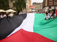 People attend solidarity with Palestine demonstration marching in Kazimierz, the Jewish historic district in Krakow, Poland on June 30, 2024...