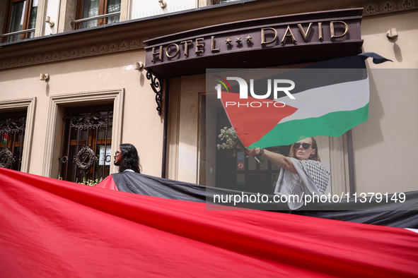 People attend solidarity with Palestine demonstration marching in Kazimierz, the Jewish historic district in Krakow, Poland on June 30, 2024...