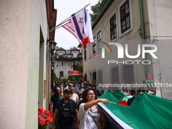 People attend solidarity with Palestine demonstration marching in Kazimierz, the Jewish historic district in Krakow, Poland on June 30, 2024...