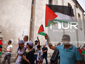 People attend solidarity with Palestine demonstration marching in Kazimierz, the Jewish historic district in Krakow, Poland on June 30, 2024...