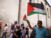 People attend solidarity with Palestine demonstration marching in Kazimierz, the Jewish historic district in Krakow, Poland on June 30, 2024...