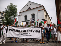 People hold 'Free Palestine' banner while attending solidarity with Palestine demonstration at Kazimierz, the Jewish historic district in Kr...