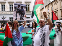 People attend solidarity with Palestine demonstration in front of the Jewish Community Center (JCC) in Kazimierz, the Jewish historic distri...