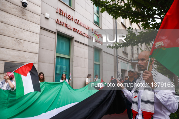 People attend solidarity with Palestine demonstration in front of the Jewish Community Center (JCC) in Kazimierz, the Jewish historic distri...