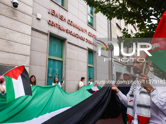 People attend solidarity with Palestine demonstration in front of the Jewish Community Center (JCC) in Kazimierz, the Jewish historic distri...