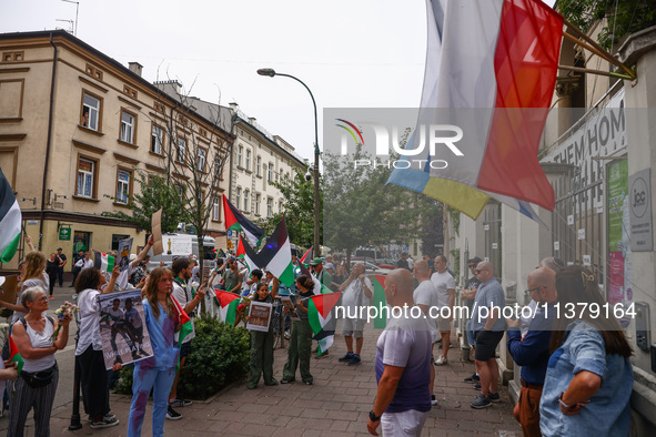 People attend solidarity with Palestine demonstration in front of the Jewish Community Center (JCC) in Kazimierz, the Jewish historic distri...