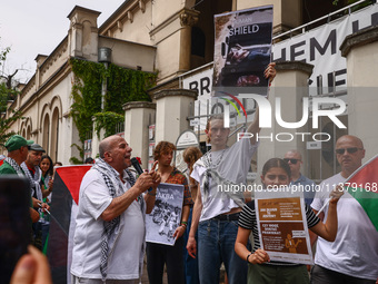 People attend solidarity with Palestine demonstration in front of the Jewish Community Center (JCC) in Kazimierz, the Jewish historic distri...