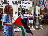 People attend solidarity with Palestine demonstration in front of the Jewish Community Center (JCC) in Kazimierz, the Jewish historic distri...