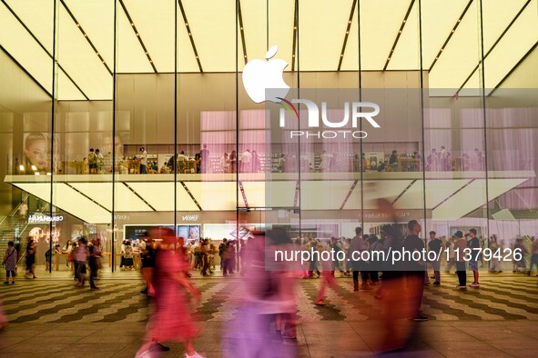 People are experiencing Apple products at an Apple product store in Hangzhou, China, on June 18, 2024. On July 2, 2024, Apple's Vision Pro s...