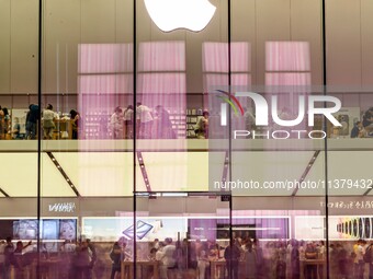 People are experiencing Apple products at an Apple product store in Hangzhou, China, on June 18, 2024. On July 2, 2024, Apple's Vision Pro s...