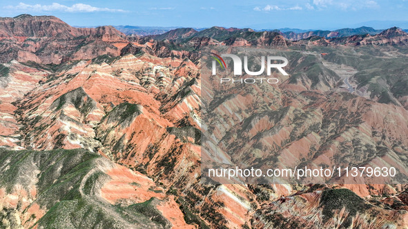 An aerial photo is showing the Danxia landform group in Xinghua village, Lanzhou city, northwest China's Gansu province, in Lanzhou, China,...