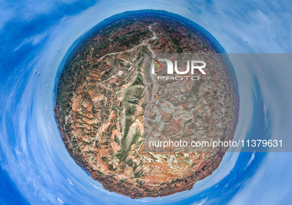 An aerial photo is showing the Danxia landform group in Xinghua village, Lanzhou city, northwest China's Gansu province, in Lanzhou, China,...