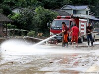 Firefighters are washing a road in Si 'an village, Rongan county, Liuzhou city, South China's Guangxi Zhuang Autonomous region, in Liuzhou,...