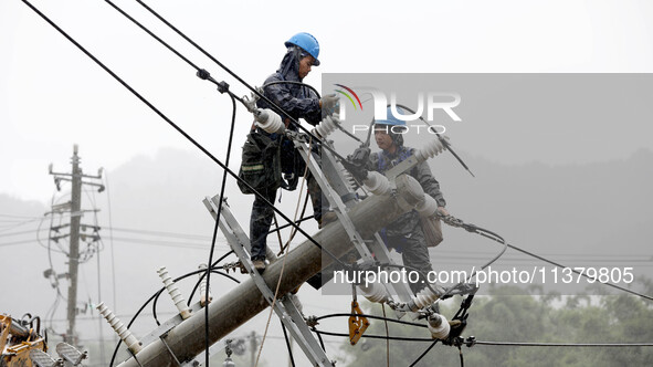 A line is being repaired in Si'an village, Rongan County, Liuzhou City, South China's Guangxi Zhuang Autonomous region, on July 2, 2024. 