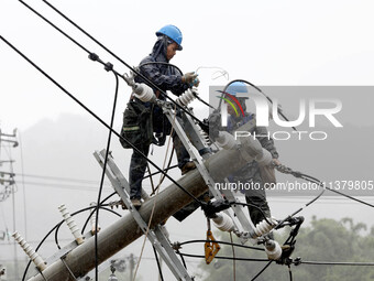 A line is being repaired in Si'an village, Rongan County, Liuzhou City, South China's Guangxi Zhuang Autonomous region, on July 2, 2024. (