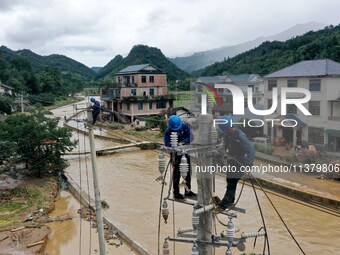 A line is being repaired in Si'an village, Rongan County, Liuzhou City, South China's Guangxi Zhuang Autonomous region, on July 2, 2024. (