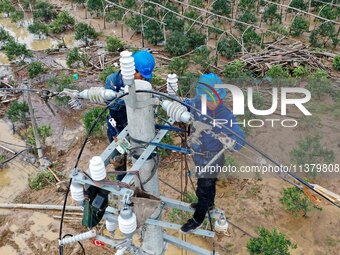 A line is being repaired in Si'an village, Rongan County, Liuzhou City, South China's Guangxi Zhuang Autonomous region, on July 2, 2024. (