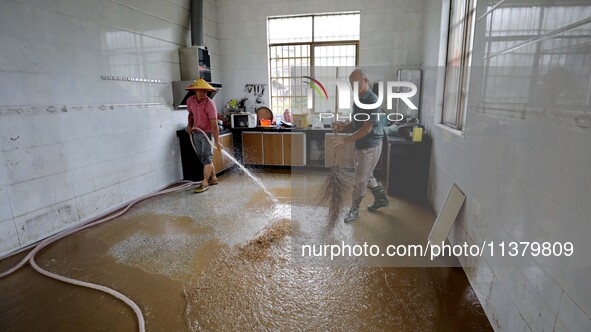 Villagers are cleaning houses soaked by floods in Si 'an village, Rongan county, Liuzhou city, South China's Guangxi Zhuang Autonomous regio...