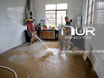 Villagers are cleaning houses soaked by floods in Si 'an village, Rongan county, Liuzhou city, South China's Guangxi Zhuang Autonomous regio...