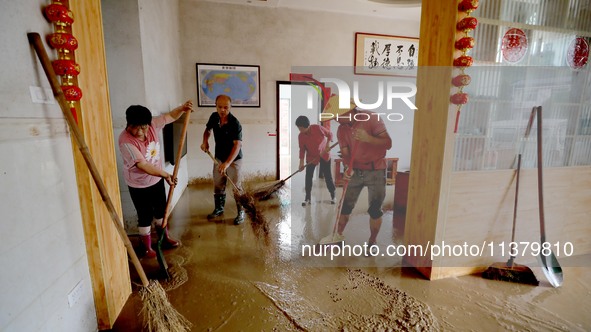 Villagers are cleaning houses soaked by floods in Si 'an village, Rongan county, Liuzhou city, South China's Guangxi Zhuang Autonomous regio...