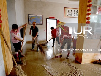 Villagers are cleaning houses soaked by floods in Si 'an village, Rongan county, Liuzhou city, South China's Guangxi Zhuang Autonomous regio...