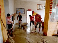 Villagers are cleaning houses soaked by floods in Si 'an village, Rongan county, Liuzhou city, South China's Guangxi Zhuang Autonomous regio...