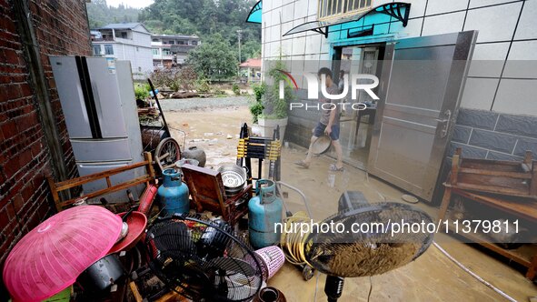 Villagers are moving furniture soaked by floods in Si 'an village, Rongan county, Liuzhou city, South China's Guangxi Zhuang Autonomous regi...