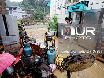 Villagers are moving furniture soaked by floods in Si 'an village, Rongan county, Liuzhou city, South China's Guangxi Zhuang Autonomous regi...