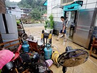 Villagers are moving furniture soaked by floods in Si 'an village, Rongan county, Liuzhou city, South China's Guangxi Zhuang Autonomous regi...