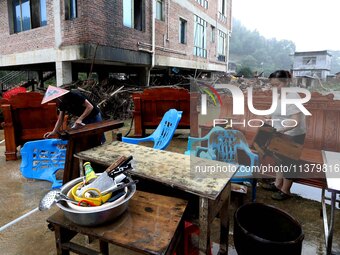 Villagers are moving furniture soaked by floods in Si 'an village, Rongan county, Liuzhou city, South China's Guangxi Zhuang Autonomous regi...