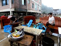 Villagers are moving furniture soaked by floods in Si 'an village, Rongan county, Liuzhou city, South China's Guangxi Zhuang Autonomous regi...