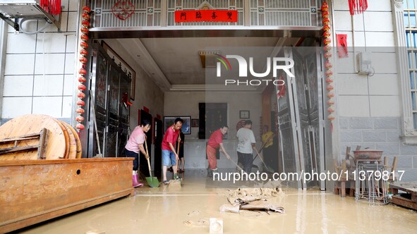 Villagers are cleaning houses soaked by floods in Si 'an village, Rongan county, Liuzhou city, South China's Guangxi Zhuang Autonomous regio...