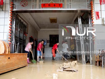 Villagers are cleaning houses soaked by floods in Si 'an village, Rongan county, Liuzhou city, South China's Guangxi Zhuang Autonomous regio...