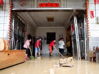 Villagers are cleaning houses soaked by floods in Si 'an village, Rongan county, Liuzhou city, South China's Guangxi Zhuang Autonomous regio...