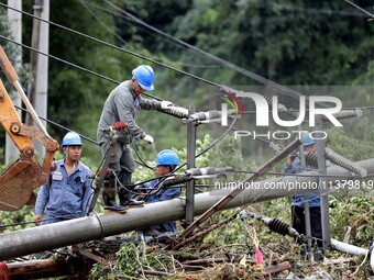 A line is being repaired in Si'an village, Rongan County, Liuzhou City, South China's Guangxi Zhuang Autonomous region, on July 2, 2024. (