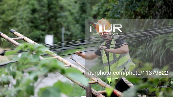 A line is being repaired in Si'an village, Rongan County, Liuzhou City, South China's Guangxi Zhuang Autonomous region, on July 2, 2024. 