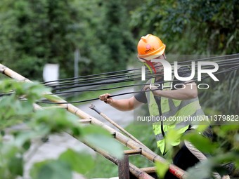 A line is being repaired in Si'an village, Rongan County, Liuzhou City, South China's Guangxi Zhuang Autonomous region, on July 2, 2024. (