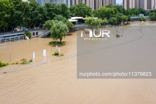 A pedestrian walkway and a platform are flooding in the Nanjing section of the Yangtze River in Nanjing, Jiangsu province, China, on July 3,...