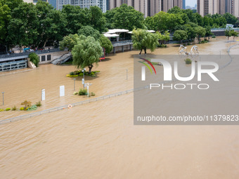 A pedestrian walkway and a platform are flooding in the Nanjing section of the Yangtze River in Nanjing, Jiangsu province, China, on July 3,...