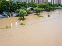 A pedestrian walkway and a platform are flooding in the Nanjing section of the Yangtze River in Nanjing, Jiangsu province, China, on July 3,...