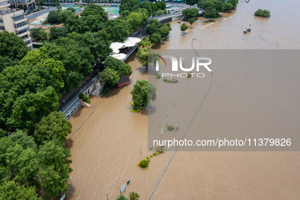 A pedestrian walkway and a platform are flooding in the Nanjing section of the Yangtze River in Nanjing, Jiangsu province, China, on July 3,...